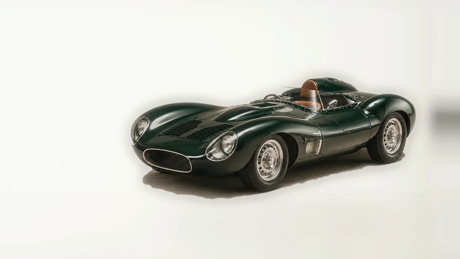 KIDULTS original deep green racing roadster in a warm limestone studio